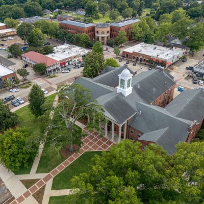 Bird's-eye aerial view of the historic brick courthouse and surrounding downtown city square in Hernando, Mississippi