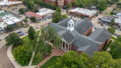 Bird's-eye aerial view of the historic brick courthouse and surrounding downtown city square in Hernando, Mississippi