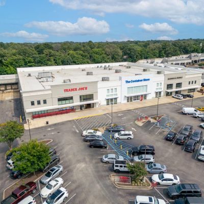Aerial drone view of a retail shopping plaza in Germantown featuring Trader Joe's, The Container Store, and Barnes & Noble bordering a large parking lot.