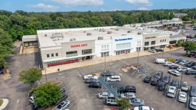 Aerial drone view of a retail shopping plaza in Germantown featuring Trader Joe's, The Container Store, and Barnes & Noble bordering a large parking lot.