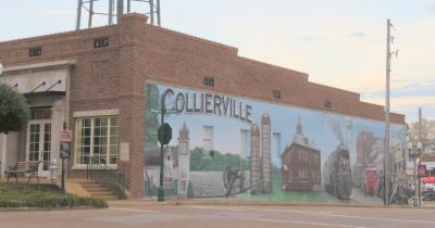Collierville Tennessee historic downtown building with a large painted mural depicting local landmarks and the iconic Collierville water tower overhead