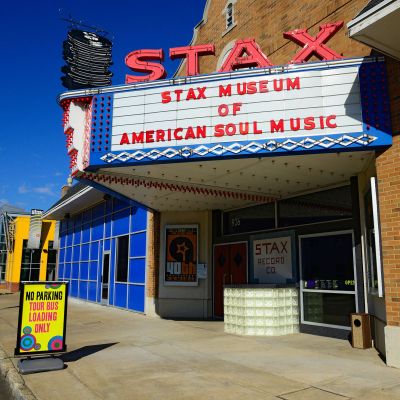 Exterior of the Stax Museum of American Soul Music in South Memphis, featuring its iconic red neon marquee sign and colorful facade