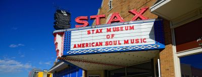 Exterior of the Stax Museum of American Soul Music in South Memphis, featuring its iconic red neon marquee sign and colorful facade