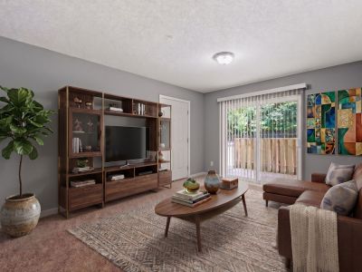 Virtually staged living room featuring a brown leather sectional, a mid-century media console, and a sliding glass door patio entrance at Annie's Townhomes and Apartments in Memphis.