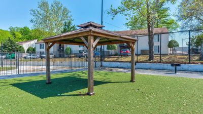 Wooden gazebo on green turf inside the gated community grounds at Annie's Townhomes and Apartments in Memphis.