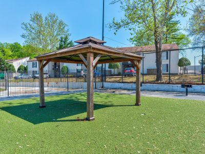 Wooden gazebo on green turf inside the gated community grounds at Annie's Townhomes and Apartments in Memphis.
