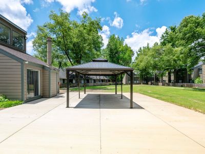 Close-up view of the dark-roofed metal gazebo structure built over a concrete pad next to a community building at The Birches Townhomes in South Memphis.