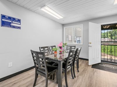 Indoor meeting or dining space inside the office center equipped with a polished dark table and chairs at The Birches Townhomes in South Memphis.