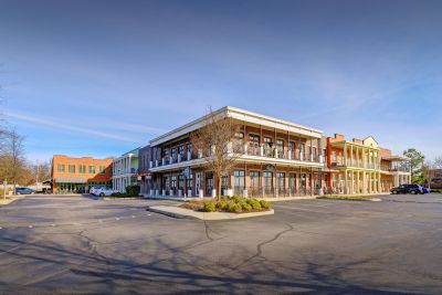 Exterior street view of mixed-use retail and residential buildings with second-story balconies at the Lofts in Town Square loft apartments in Southaven.