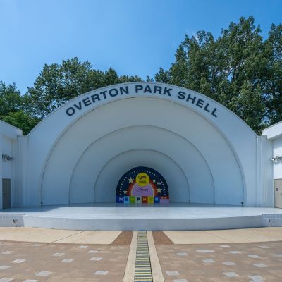 Front view of the iconic open-air Overton Park Shell amphitheater stage under a bright blue sky in Midtown Memphis