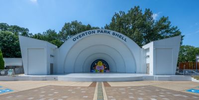 Front view of the iconic open-air Overton Park Shell amphitheater stage under a bright blue sky in Midtown Memphis