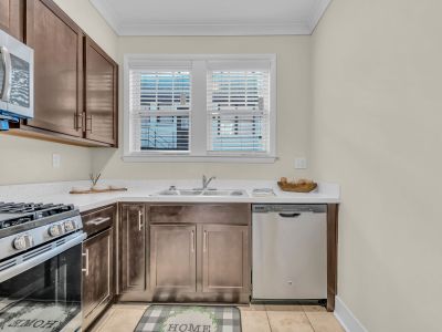 Upgraded kitchen work area highlighting a stainless steel under-mount sink, dishwasher, and white quartz countertops at Stratford Place apartments in Memphis.