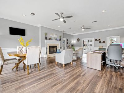 Spacious resident clubhouse lounge with a fireplace, leasing desk, and seating options at Monticello apartments in Memphis.