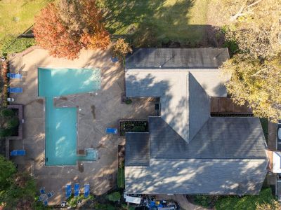Aerial drone view of the community swimming pool and residential building roof at Rocky Creek Apartments in Southaven, Mississippi.