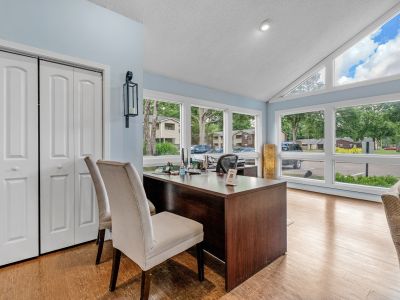 Leasing office desk area with wood-style floors and large windows providing natural light at Rocky Creek Apartments in Southaven, Mississippi.