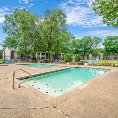 Dual outdoor community swimming pools surrounded by concrete decking and lounge chairs at Rocky Creek Apartments in Southaven, Mississippi.