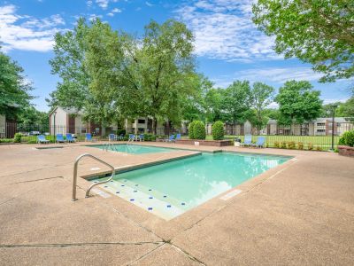 Dual outdoor community swimming pools surrounded by concrete decking and lounge chairs at Rocky Creek Apartments in Southaven, Mississippi.
