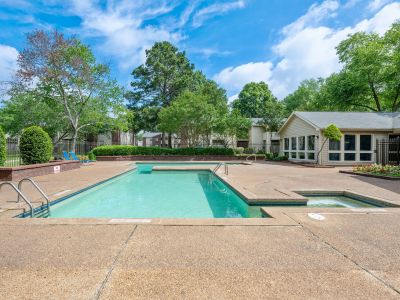 Sparkling community swimming pool and hot tub spa next to the leasing clubhouse at Rocky Creek Apartments in Southaven, Mississippi.