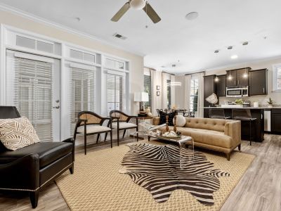 Contemporary open living room with a zebra-print rug and chic leather furniture at The Signature at Schilling Farms apartments in Collierville near Memphis.