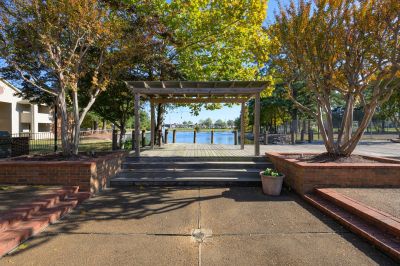 Wooden pergola over a waterfront viewing deck surrounded by autumn trees at Southcrest Lake Apartments in Southaven