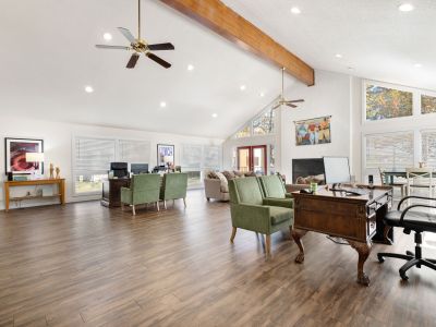 Spacious community clubhouse with high vaulted ceilings, exposed wood beams, and a leasing office at Southcrest Lake Apartments in Southaven,