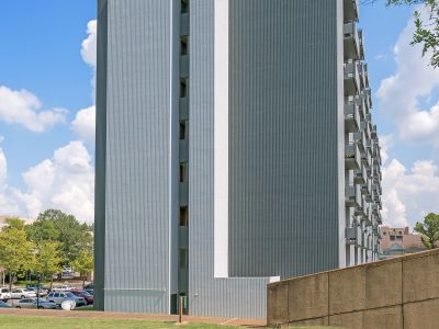Tall residential structure with The Edison Apartments signage on a grassy lawn in downtown Memphis.