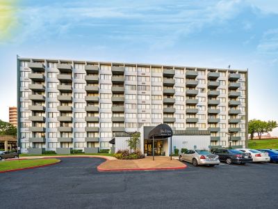 Exterior view of the multi-story high-rise building and parking lot at Edison Park apartments in downtown Memphis