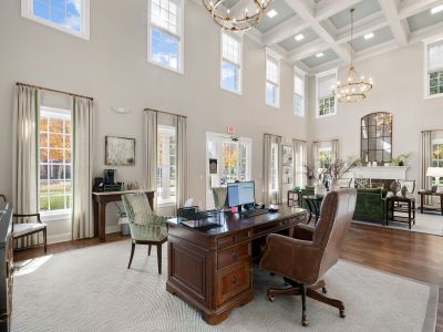 Grand leasing office lobby reception area with double-height ceilings, a coffered panel design, and elegant chandeliers at The Westbury apartments near Germantown.