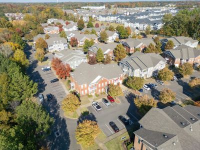 Bird's-eye view showcasing the distinct apartment buildings, paved surface parking lots, and autumn trees at The Westbury apartments near Germantown.