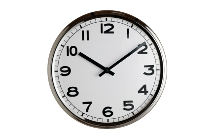 Classic clock on wall reads ten past ten isolated on white background